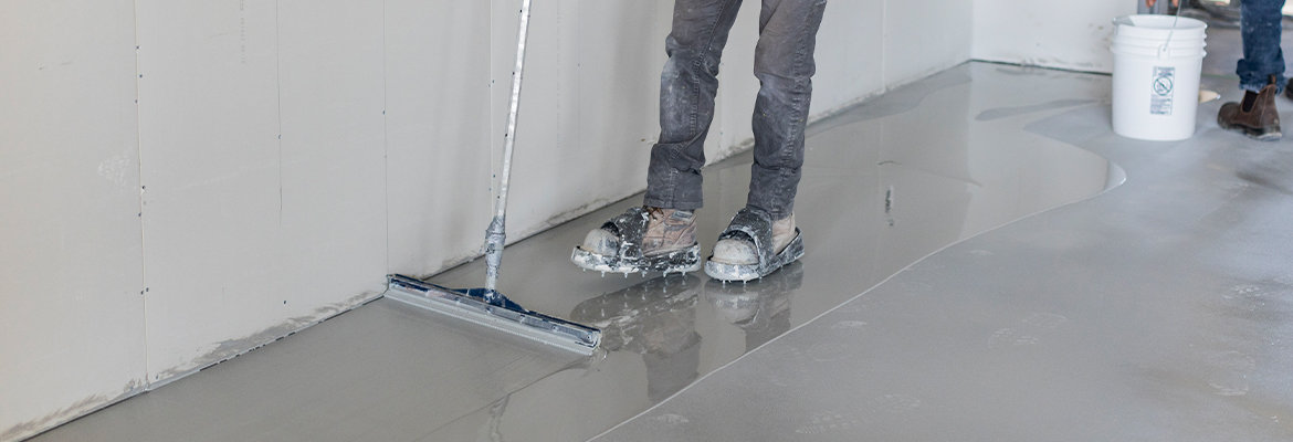 Urethane concrete coating being applied by worker